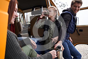 Family drinking hot tea at the nature