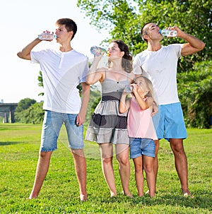 Family drinking water during walk
