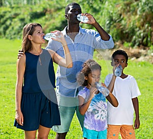 Family drinking water on walk