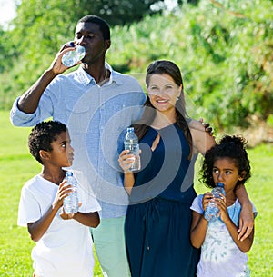 Family drinking water during walk