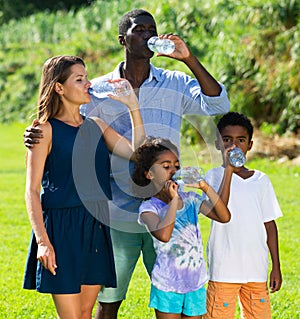 Family drinking water on walk