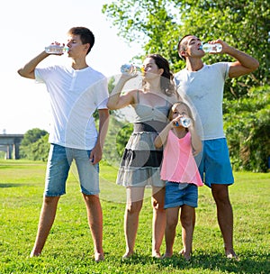 Family drinking water during walk