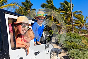 Family driving off-road car on tropical beach