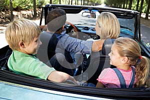 Family driving in sports car