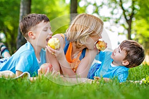 Family eating apple in the nature