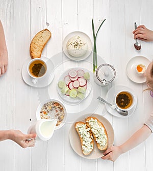 Family eating breakfast , toasts with cottage cheese, topview