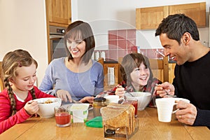 Family Eating Breakfast Together In Kitchen