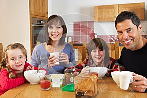 Family Eating Breakfast Together In Kitchen