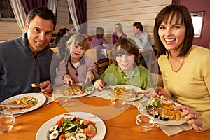 Family Eating Lunch Together In Restaurant