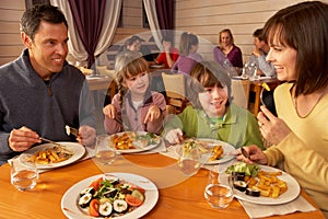 Family Eating Lunch Together In Restaurant