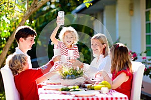 Family eating outdoor. Garden summer fun