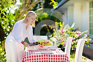 Family eating outdoor. Garden summer fun