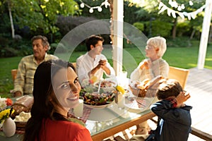 Family eating outside together in summer