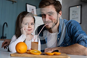 Family, eating and people concept - happy father and daughter having breakfast at home