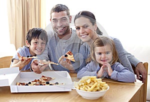 Family eating pizza and fries at home