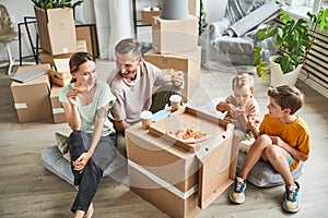 Family Eating Pizza in New Home