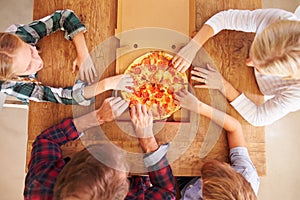 Family eating pizza together, overhead view