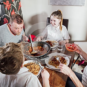 Family Eating Spagetti Bolognese Tgoether photo