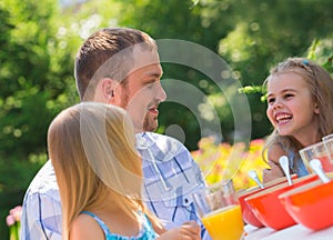 Family eating together outdoors