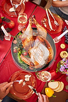 Family eating traditional Thanksgiving turkey on a festive table background. Roasted turkey. Family celebration concept.