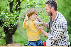 Family enjoy homemade meal. Father son eat food and have fun. Little boy and dad eating. Nutrition for kids and adults