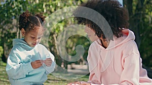 Family enjoy lunch picnic sitting park close up. African woman giving sandwich.