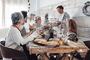 Family enjoy together christmas lunch at home - caucasian people have fun in friendship celebrating holidays and eve - white home