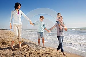 Family enjoyed walking on the beach at the sea photo
