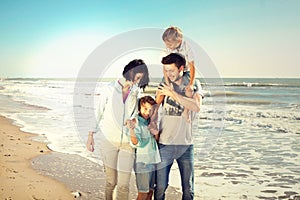 Family enjoyed walking on the beach at the sea