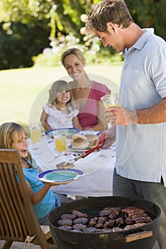 Family Enjoying A Barbeque