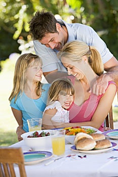 Family Enjoying A Barbeque photo