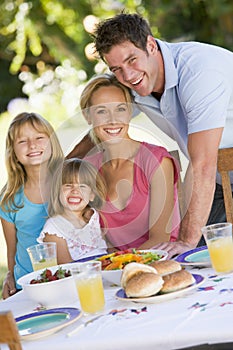 Family Enjoying A Barbeque