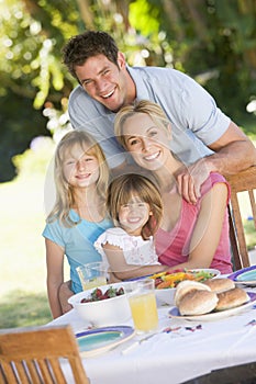 Family Enjoying A Barbeque