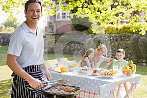 Family Enjoying A Barbeque