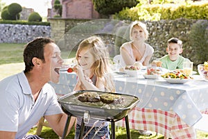 Family Enjoying A Barbeque