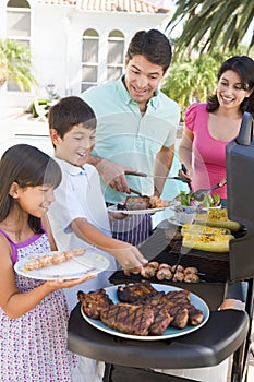 Family Enjoying A Barbeque