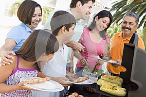 Family Enjoying A Barbeque