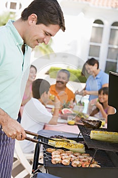 Family Enjoying A Barbeque