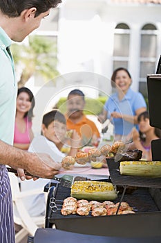 Family Enjoying A Barbeque