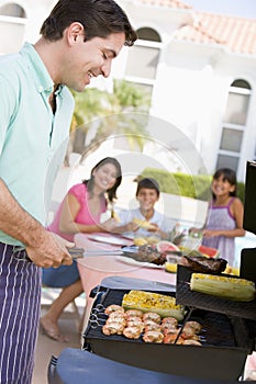 Family Enjoying A Barbeque