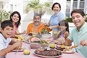 Family Enjoying A Barbeque