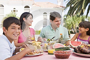 Family Enjoying A Barbeque