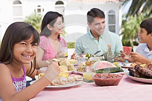 Family Enjoying A Barbeque