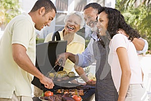 Family Enjoying A Barbeque