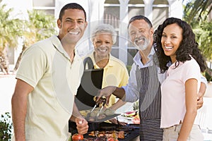 Family Enjoying A Barbeque