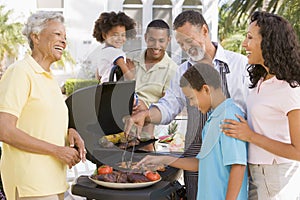 Family Enjoying A Barbeque