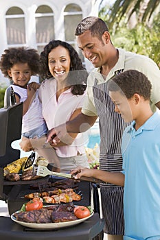 Family Enjoying A Barbeque