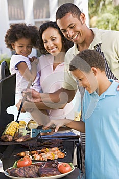 Family Enjoying A Barbeque