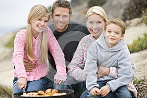Family Enjoying A Beach Barbeque