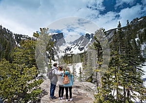 Family enjoying beautiful scenery on spring mountain hiking trip.